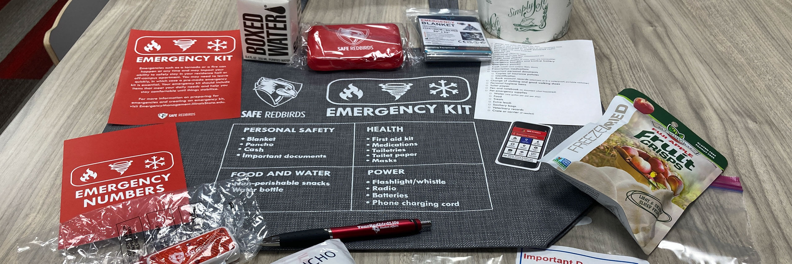 An Emergency Kit is laid out on a table.
